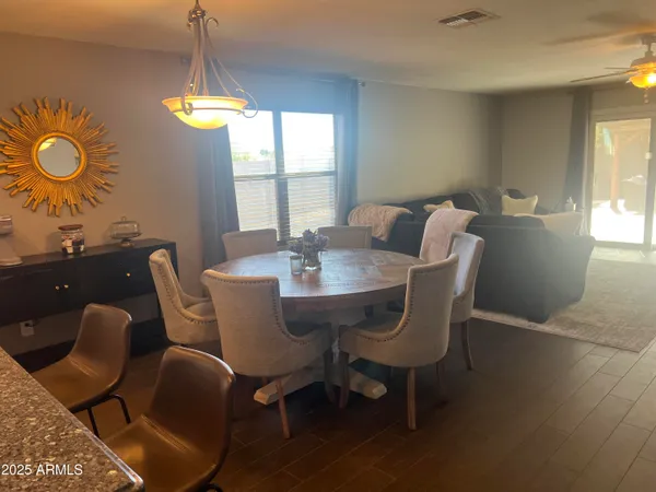a view of a dining room with furniture and window