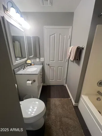 a bathroom with a sink a toilet a mirror and shower