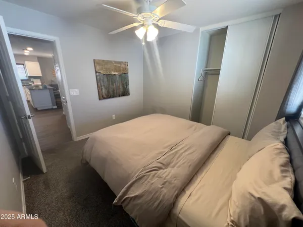 a bedroom with a bed and a chandelier