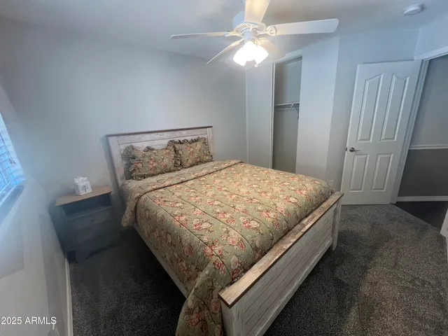 a bed sitting in a bedroom next to a window