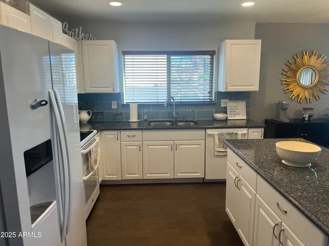 a kitchen with a sink stove and cabinets