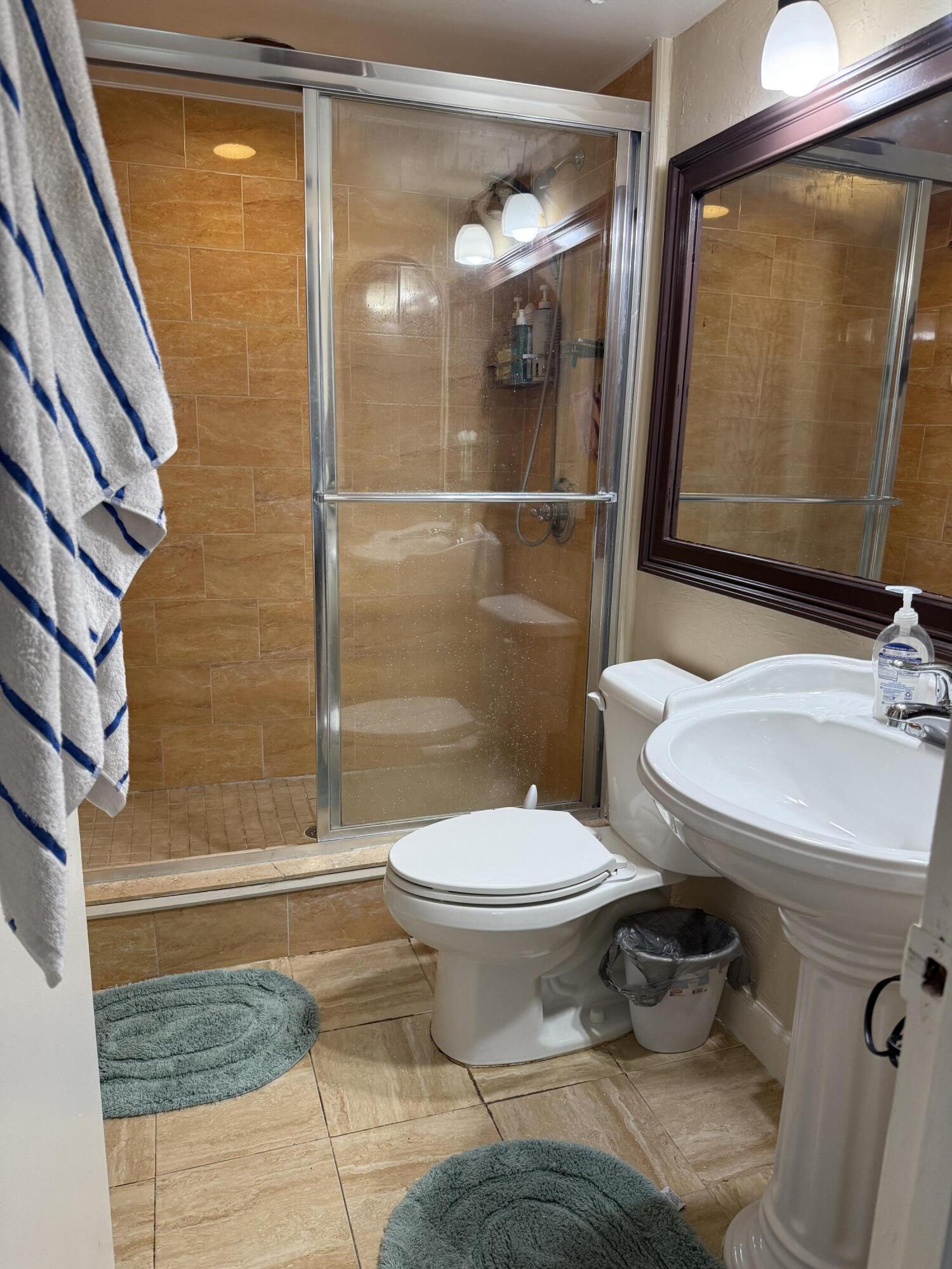 721 Sunny Pine Way, Unit A1 Greenacres, FL 33415 - Photo 10 of 10 a bathroom with a sink toilet and shower