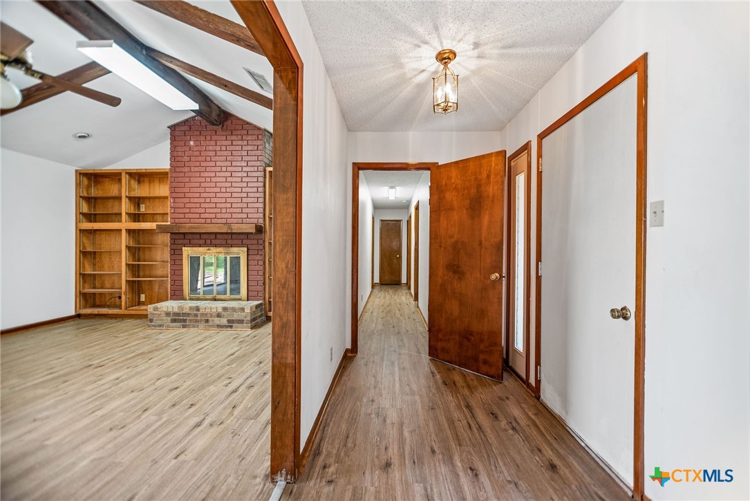 181 Pecan Street Port Lavaca, TX 77979 - Photo 12 of 34 a view of a hallway with wooden floor and staircase