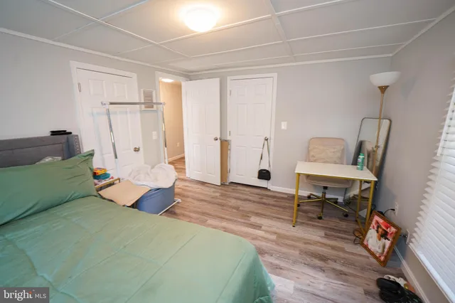 a bedroom with a bed and a chair in it