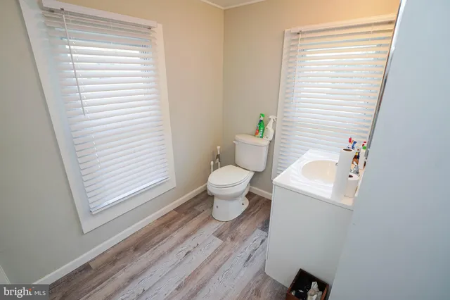a bathroom with a sink a toilet and a window