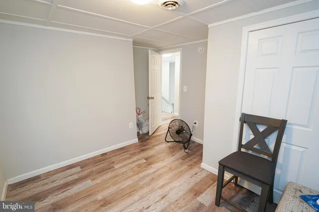 a room with a chair and wooden floor