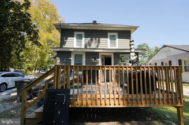 a view of a house with wooden fence
