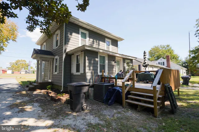 a view of a house with backyard sitting area and garden