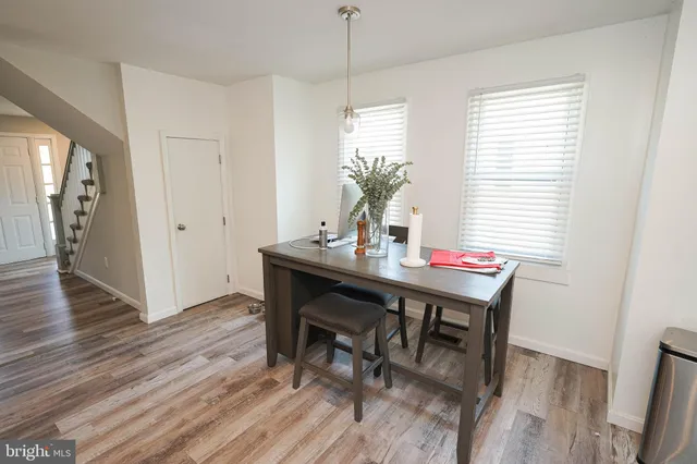 a dining room with furniture and wooden floor