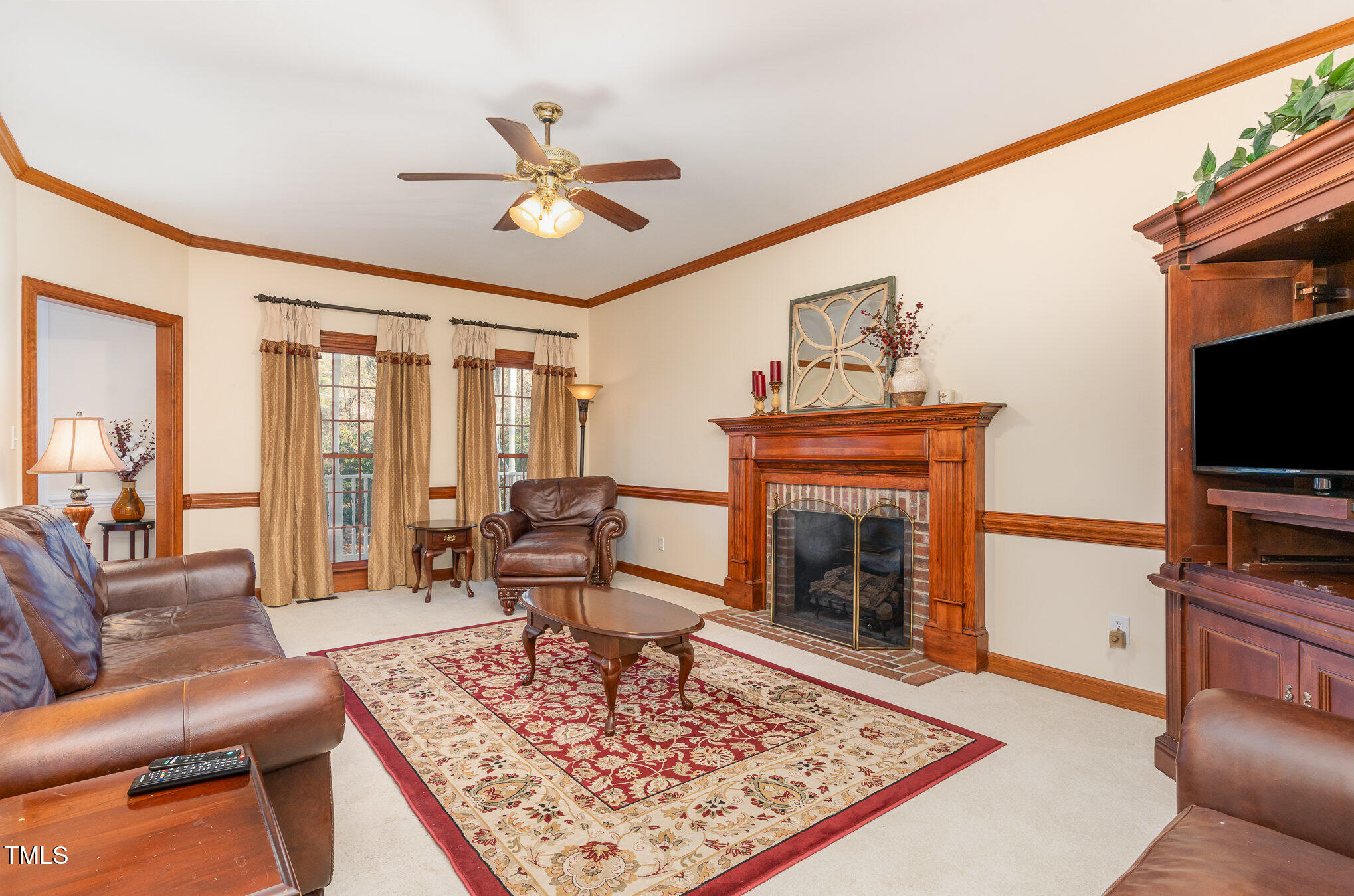 6132 Wolverhampton Drive Raleigh, NC 27603 - Photo 7 of 40 a living room with furniture a rug and a fireplace