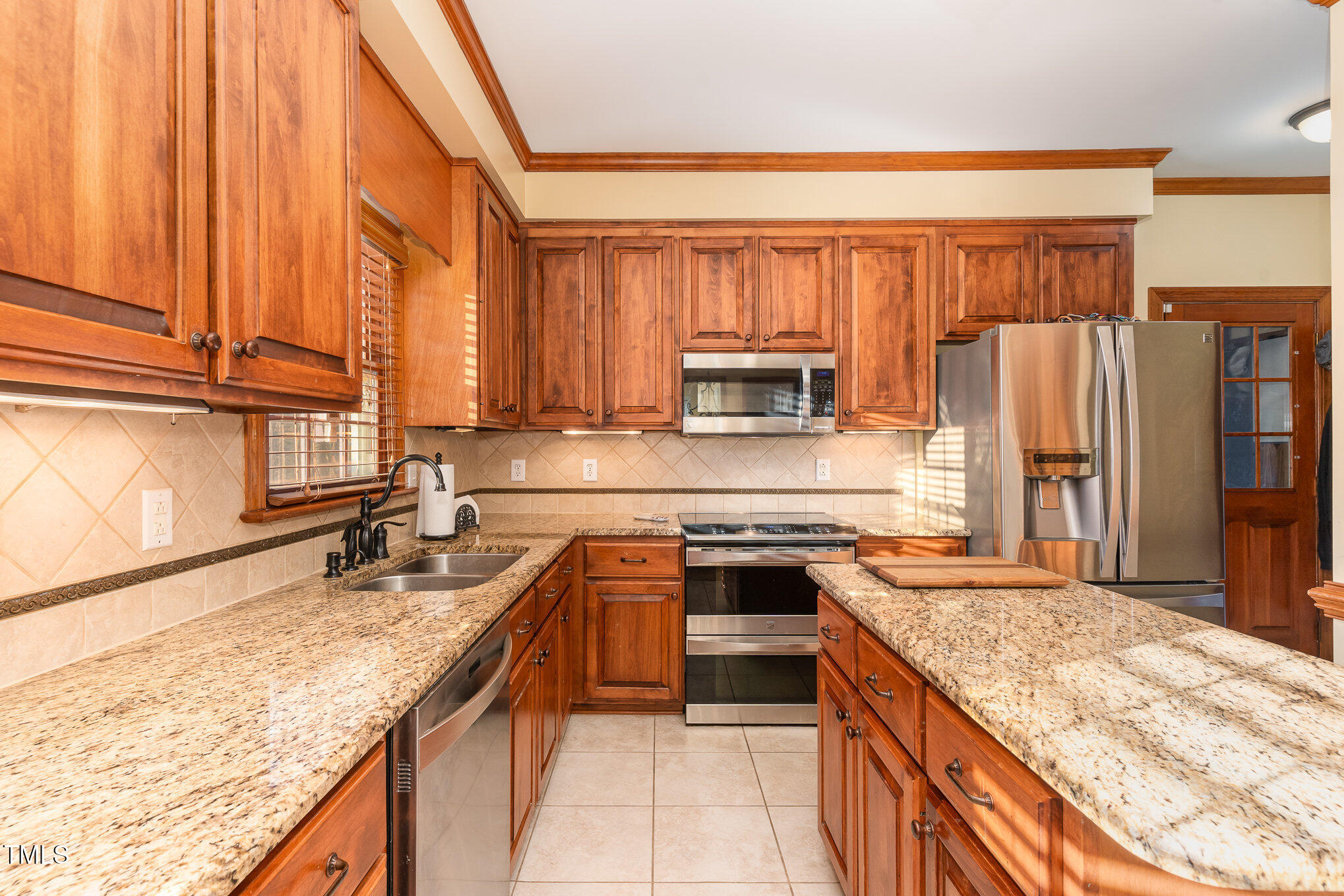 6132 Wolverhampton Drive Raleigh, NC 27603 - Photo 10 of 40 a kitchen with stainless steel appliances granite countertop a sink stove and refrigerator