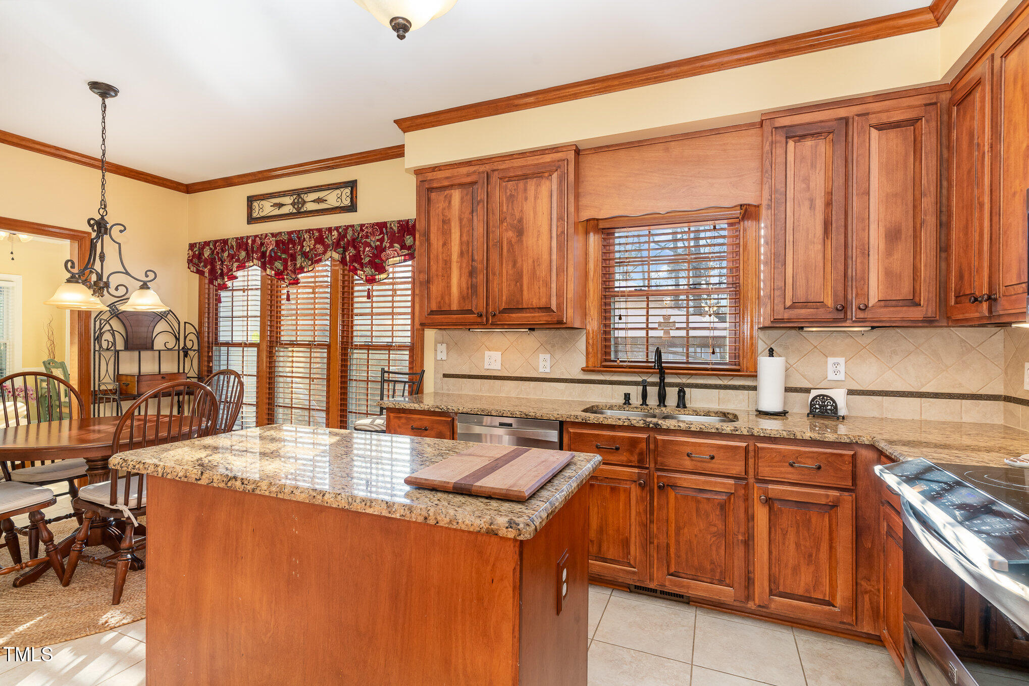 6132 Wolverhampton Drive Raleigh, NC 27603 - Photo 11 of 40 a kitchen with a sink stove and cabinets