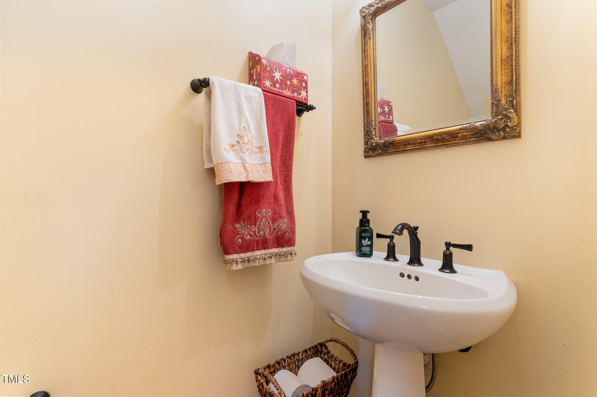 6132 Wolverhampton Drive Raleigh, NC 27603 - Photo 16 of 40 a bathroom with a sink and a mirror