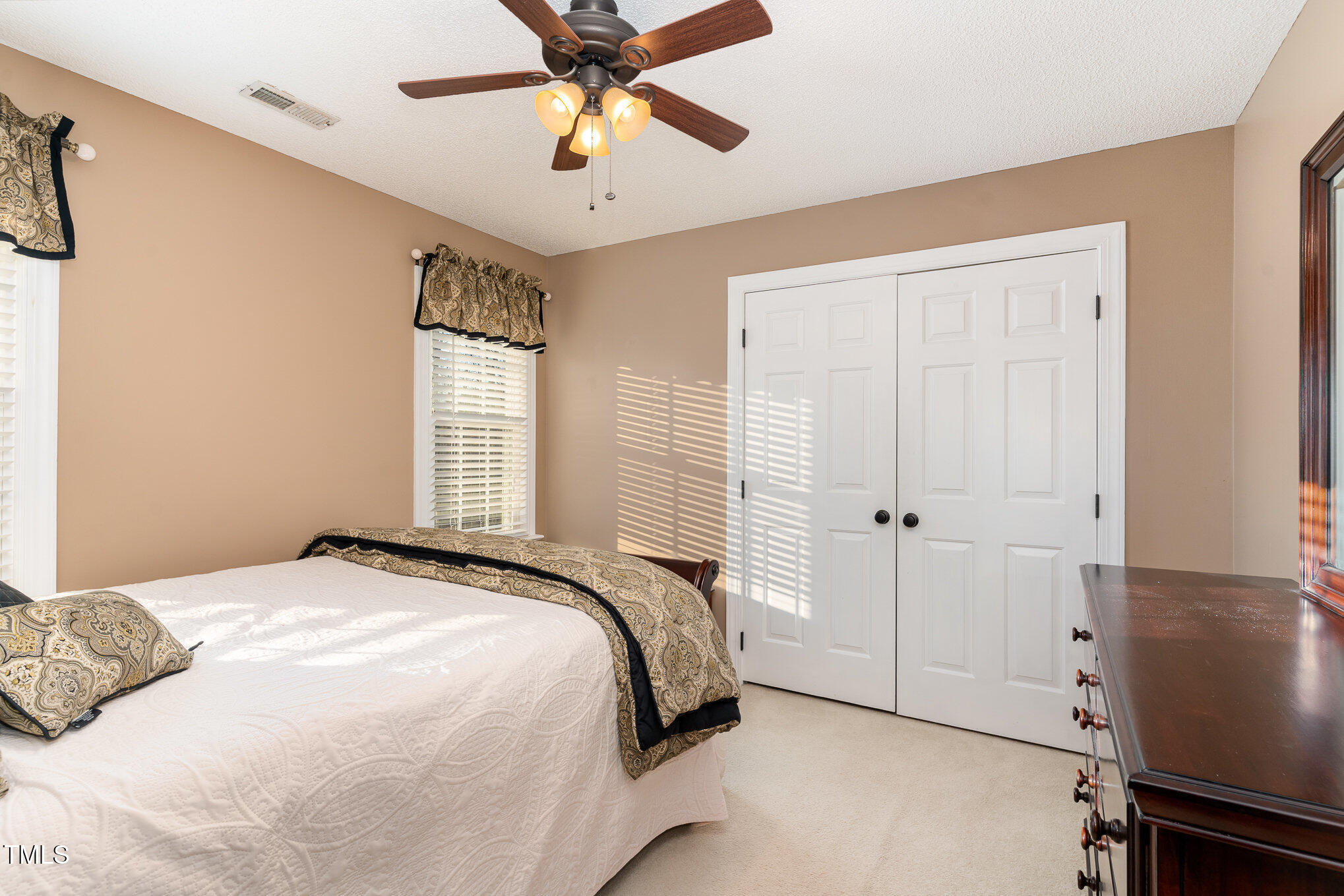 6132 Wolverhampton Drive Raleigh, NC 27603 - Photo 21 of 40 a bedroom with a bed and a chandelier