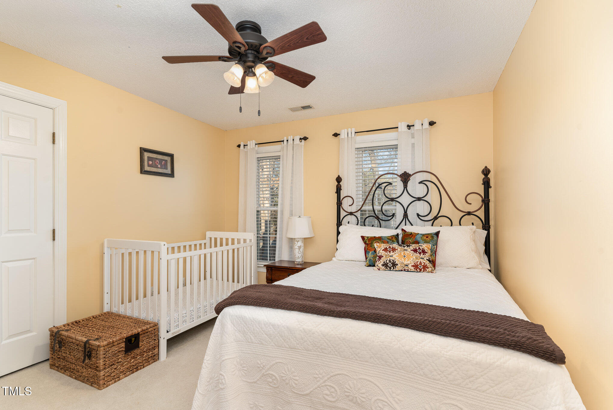 6132 Wolverhampton Drive Raleigh, NC 27603 - Photo 22 of 40 a bedroom with a bed and a chandelier