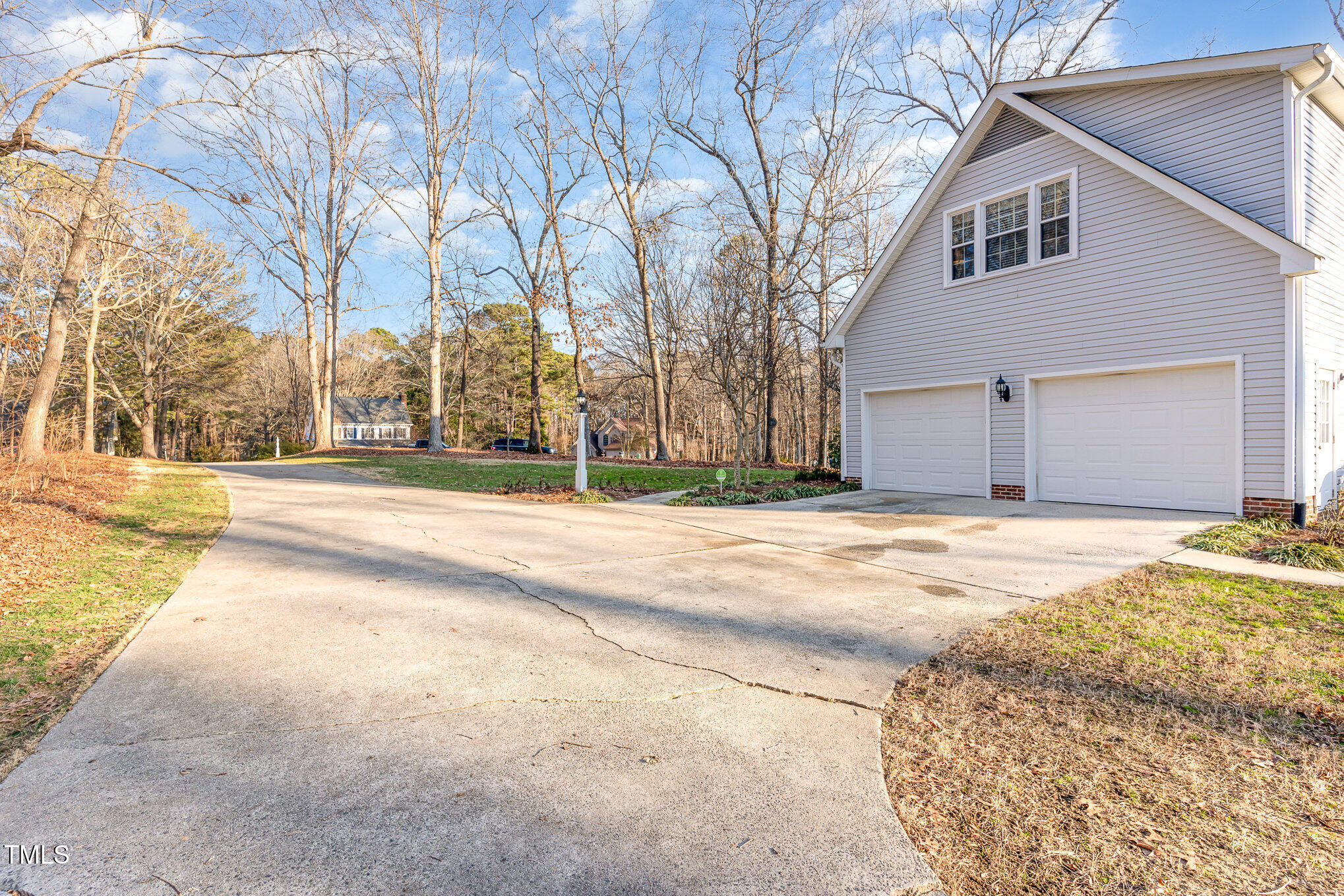 6132 Wolverhampton Drive Raleigh, NC 27603 - Photo 28 of 40 a view of a house with snow on the road