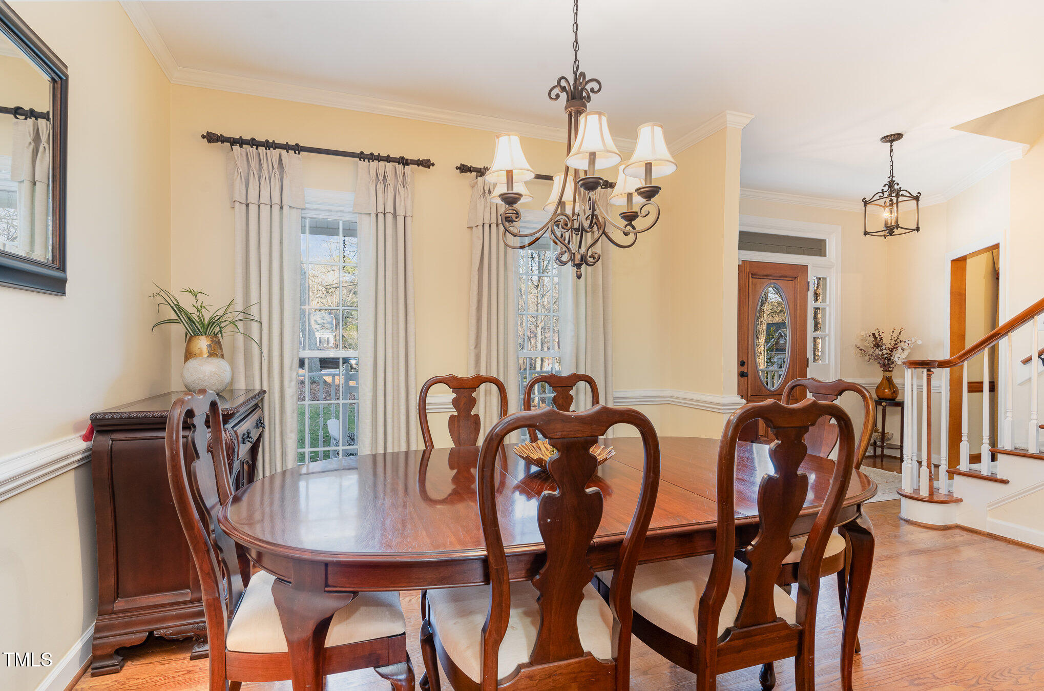 6132 Wolverhampton Drive Raleigh, NC 27603 - Photo 6 of 40 a view of a dining room with furniture and chandelier