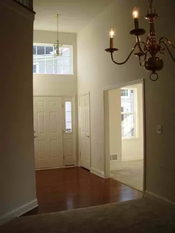 a view of a room with wooden floor and windows