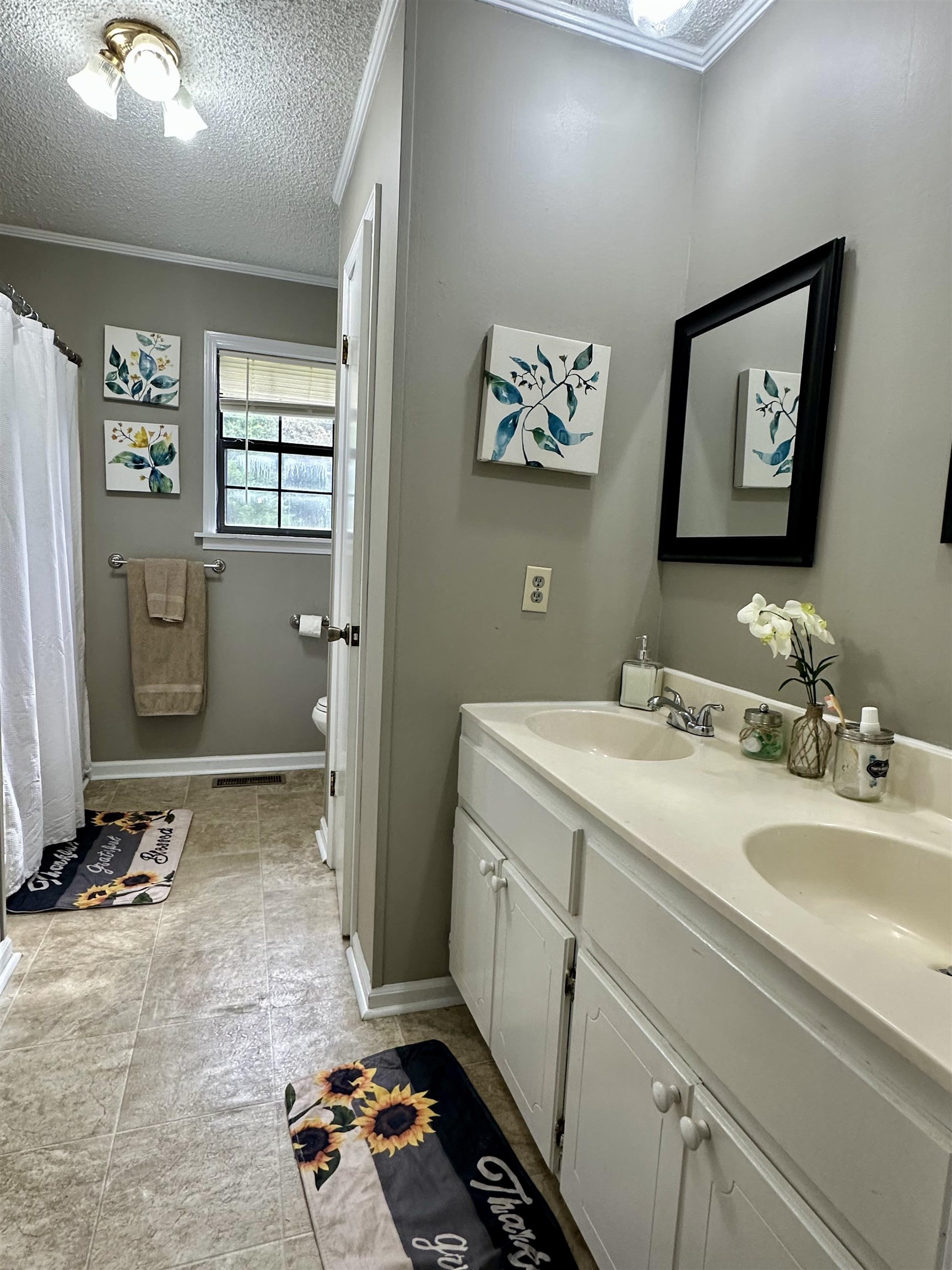 320 Clayton Road Finger, TN 38334 - Photo 11 of 16 a bathroom with a sink a mirror and a toilet