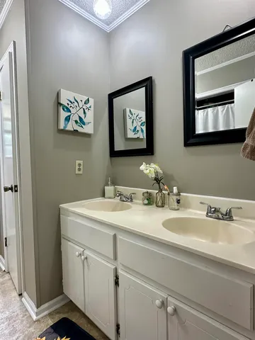 a bathroom with a granite countertop sink mirror and vanity