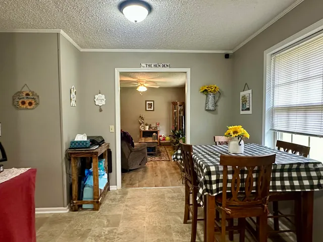 a view of a dining room with furniture and chandelier