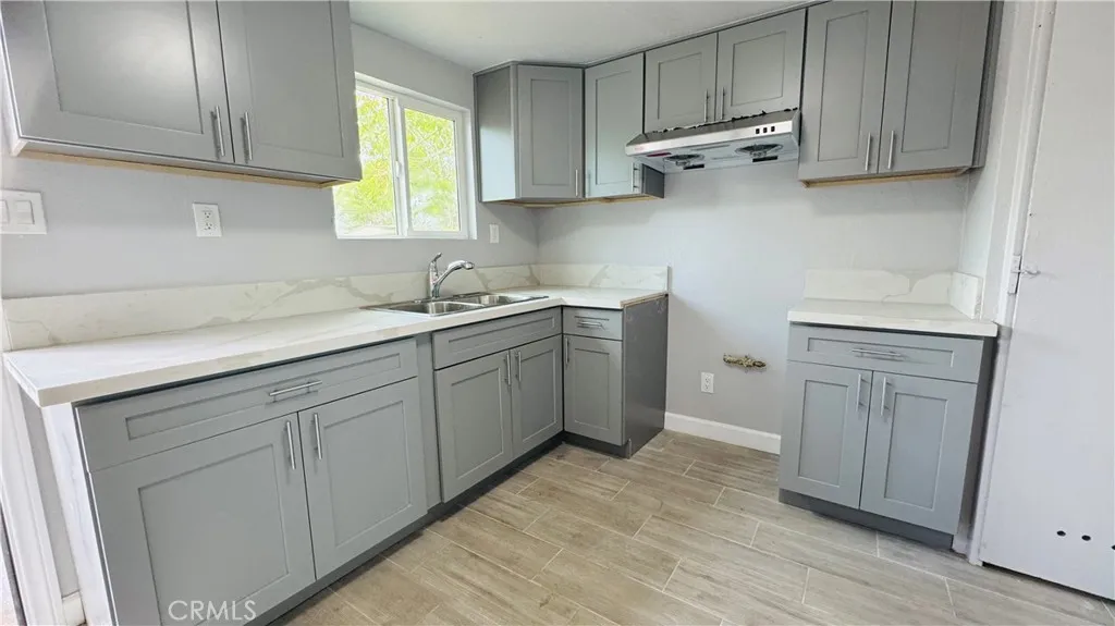 2523 Ogden Street Muscoy, CA 92407 - Photo 13 of 31 a kitchen with a sink cabinets and window