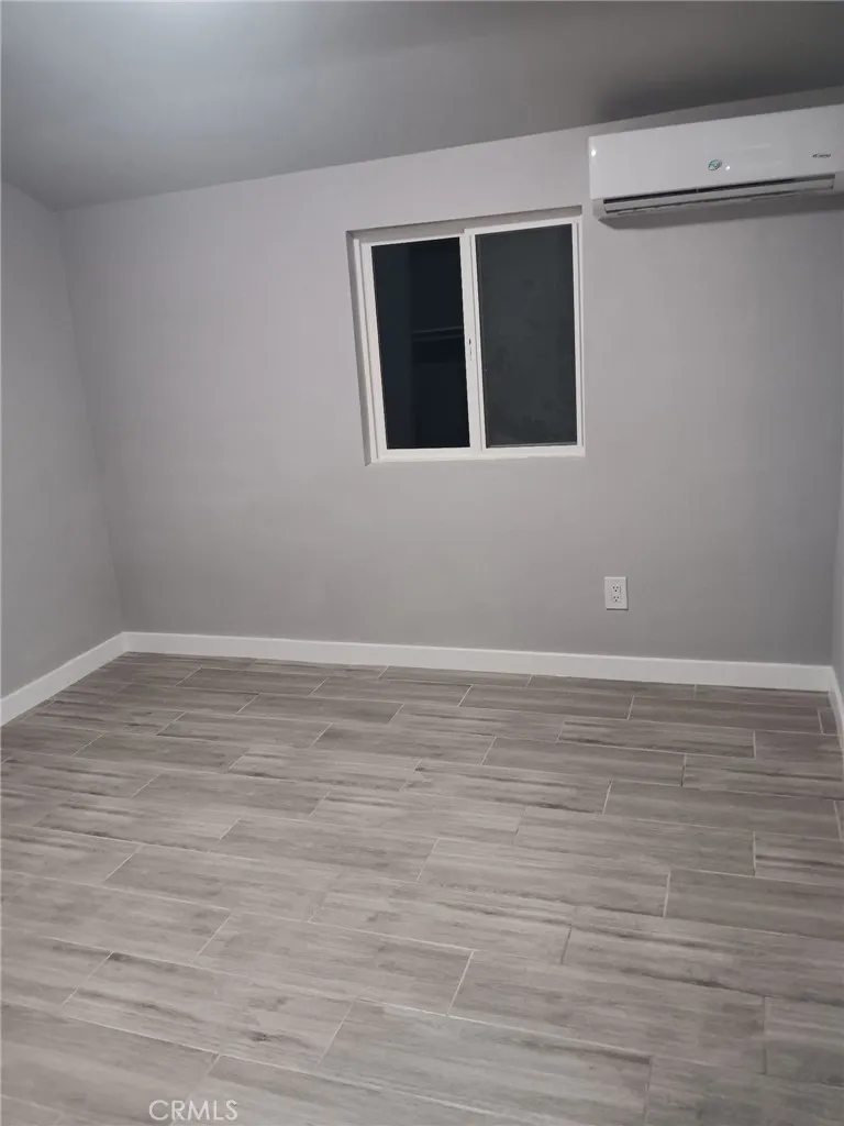 2523 Ogden Street Muscoy, CA 92407 - Photo 17 of 31 a view of an empty room with wooden floor