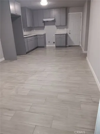a view of a kitchen with white cabinets