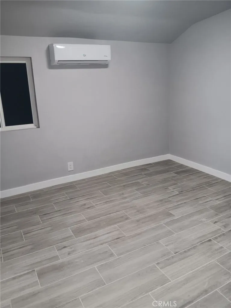 2523 Ogden Street Muscoy, CA 92407 - Photo 20 of 31 a view of an empty room with wooden floor