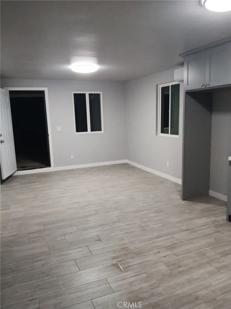 2523 Ogden Street Muscoy, CA 92407 - Photo 21 of 31 a view of an empty room with wooden floor