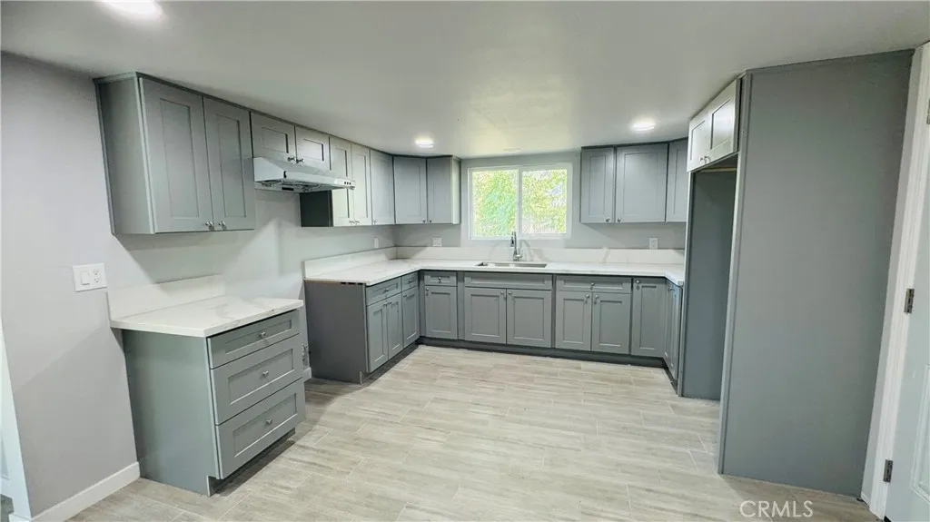 2523 Ogden Street Muscoy, CA 92407 - Photo 25 of 31 a kitchen with stainless steel appliances granite countertop a sink a stove a refrigerator and cabinets