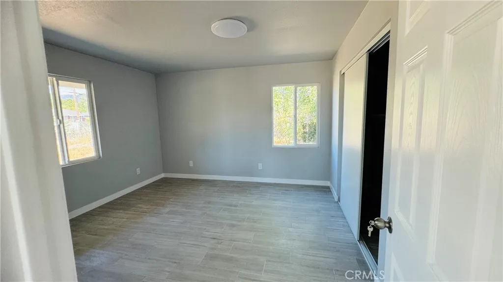 2523 Ogden Street Muscoy, CA 92407 - Photo 26 of 31 an empty room with windows
