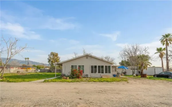 a front view of a house with a yard and road