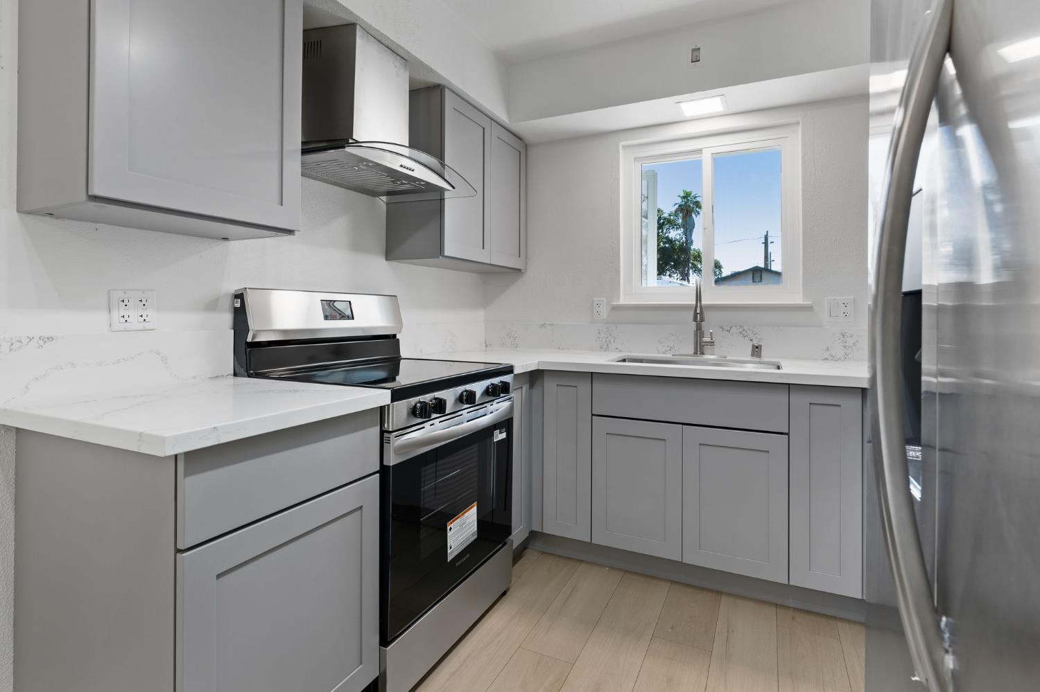 3270 Nareb Street Sacramento, CA 95838 - Photo 12 of 28 a kitchen with stainless steel appliances granite countertop a sink stove and refrigerator