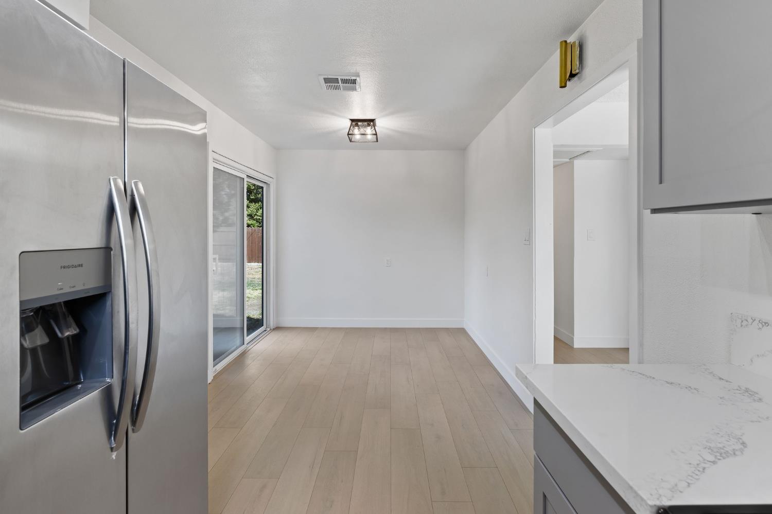 3270 Nareb Street Sacramento, CA 95838 - Photo 14 of 28 a view of a kitchen with a sink refrigerator and wooden floor
