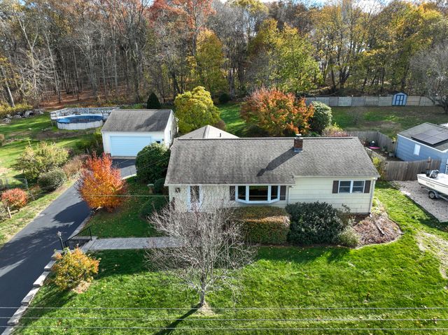 an aerial view of a house with swimming pool a yard and outdoor seating