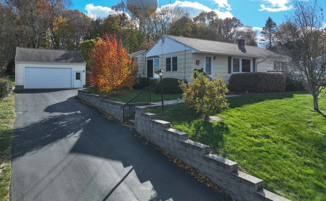 a front view of a house with a yard and a garden