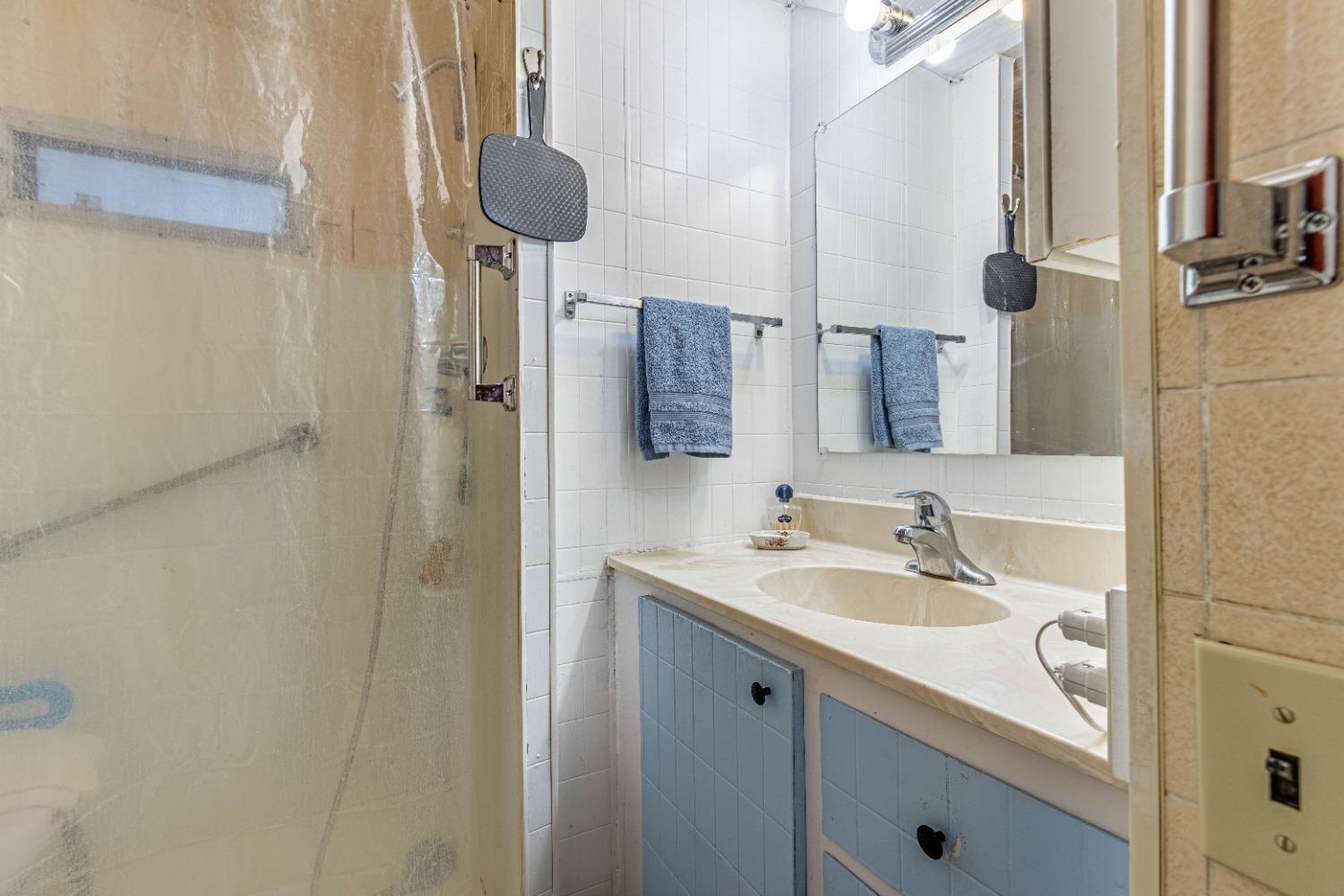 4449 South Carpenter Road, Unit D2 Modesto, CA 95358 - Photo 11 of 26 a bathroom with a sink and a mirror