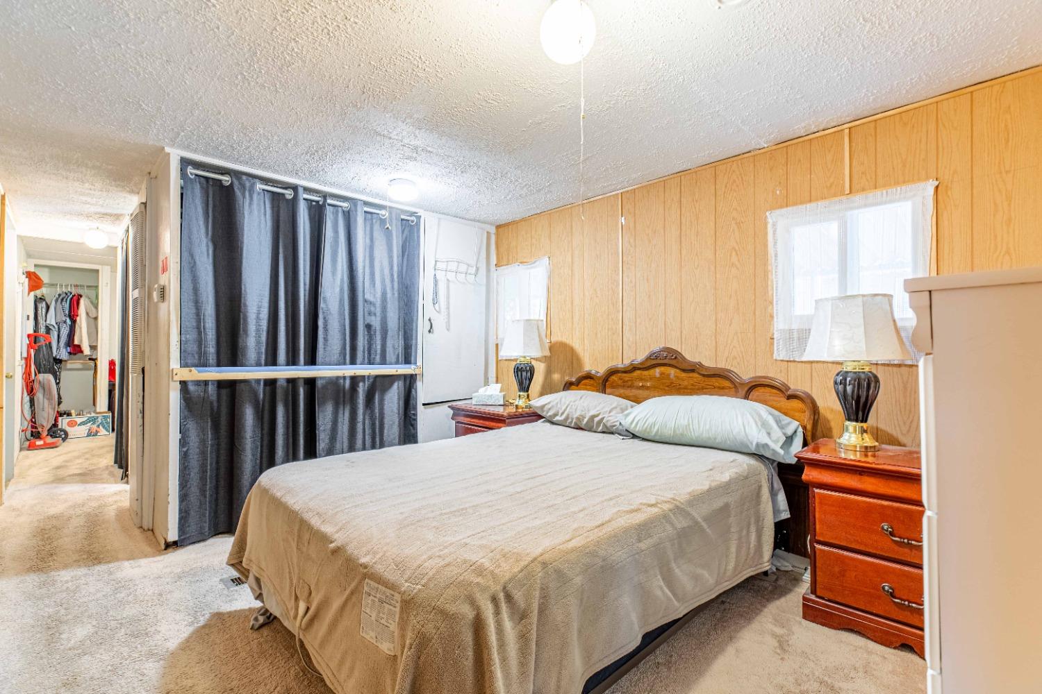 4449 South Carpenter Road, Unit D2 Modesto, CA 95358 - Photo 8 of 26 a bed room with a bed and a window