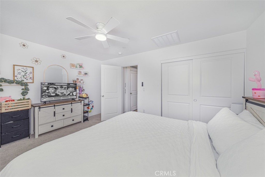 7395 Olive Grv Street Riverside, CA 92507 - Photo 14 of 18 Spacious primary room uptairs with ceiling fan and plantation shutters.