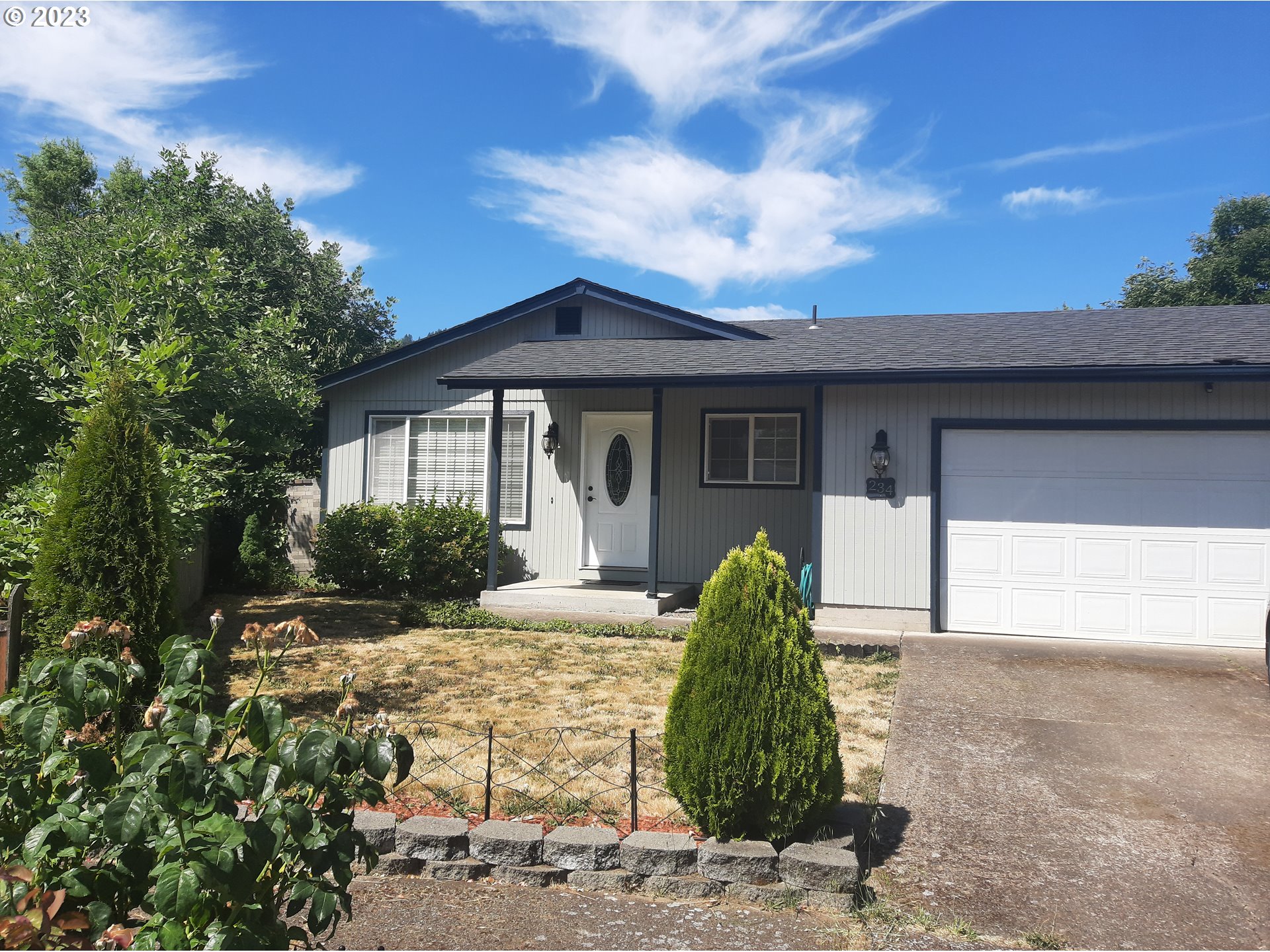 234 71st Street Springfield, OR 97478 - Photo 1 of 26 a front view of a house with a garden