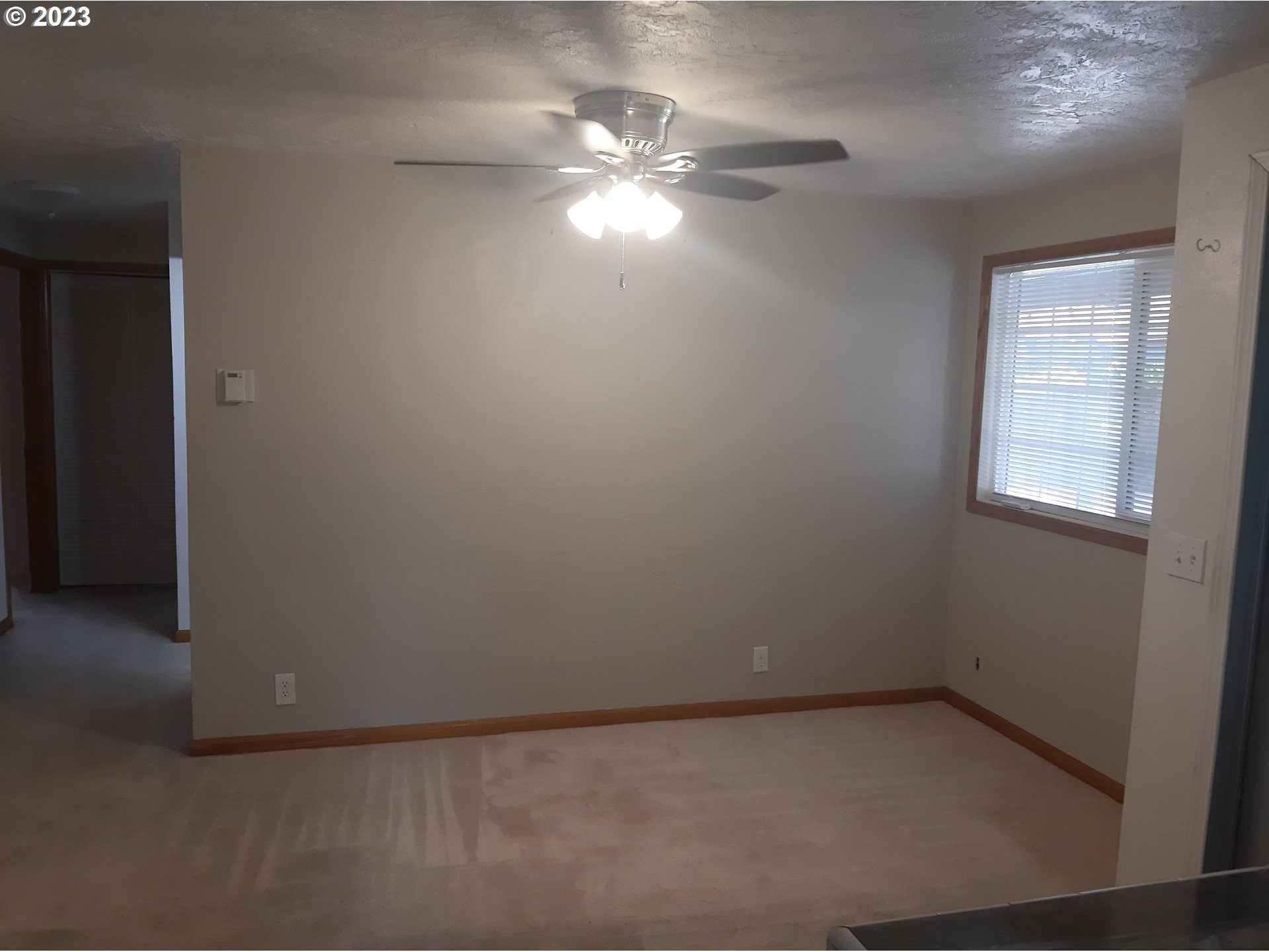 234 71st Street Springfield, OR 97478 - Photo 12 of 26 an empty room with chandelier fan and windows