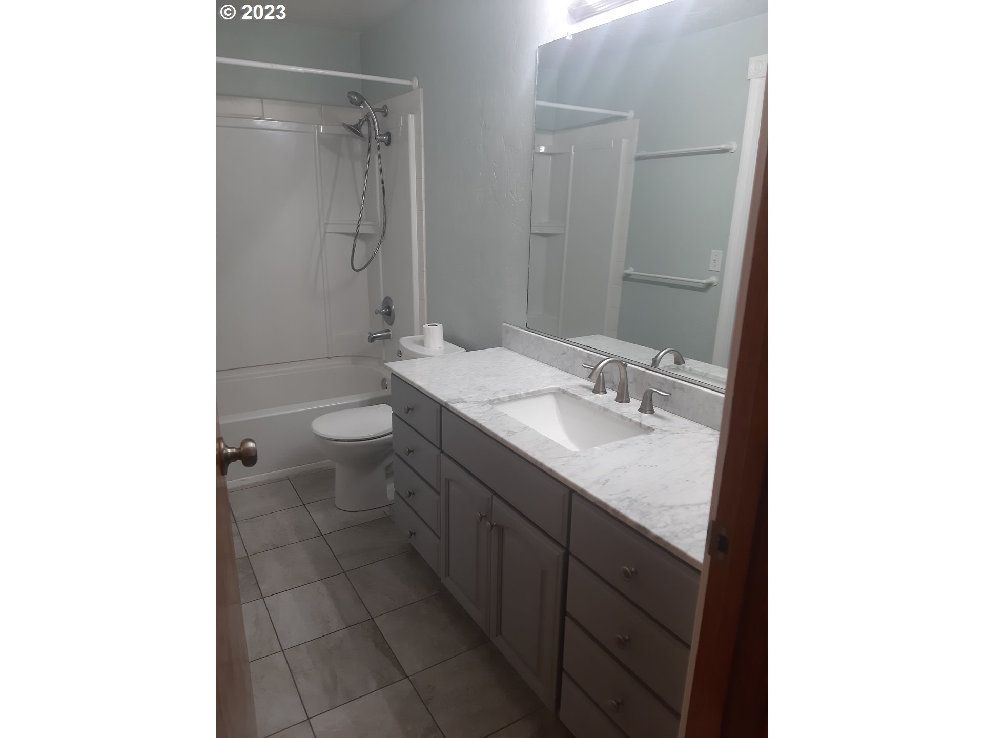 234 71st Street Springfield, OR 97478 - Photo 17 of 26 a bathroom with a granite countertop sink toilet and shower