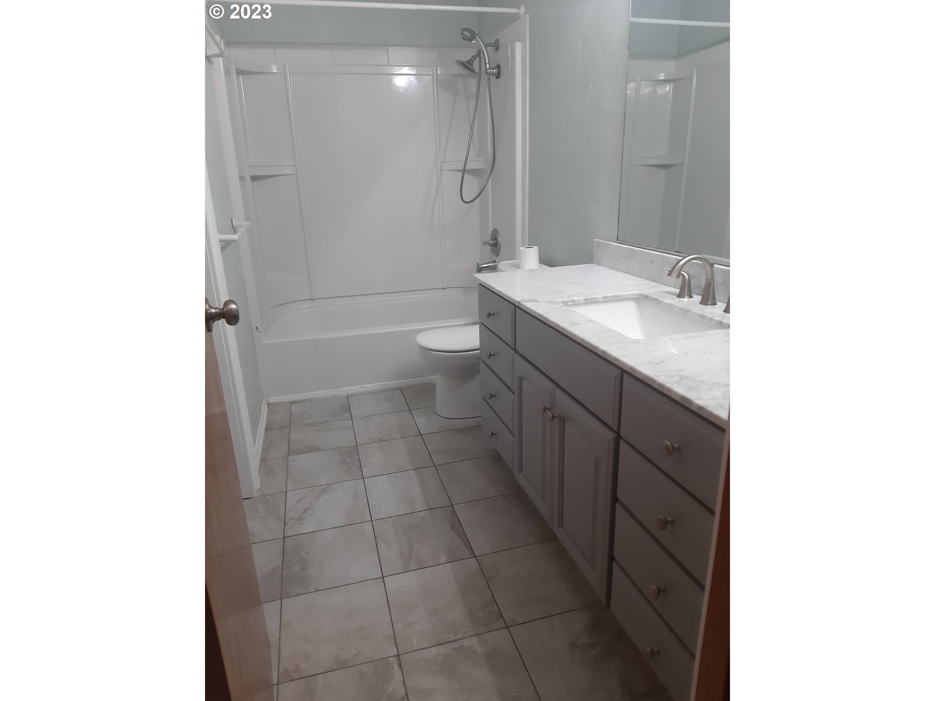 234 71st Street Springfield, OR 97478 - Photo 18 of 26 a bathroom with a granite countertop sink a toilet and shower