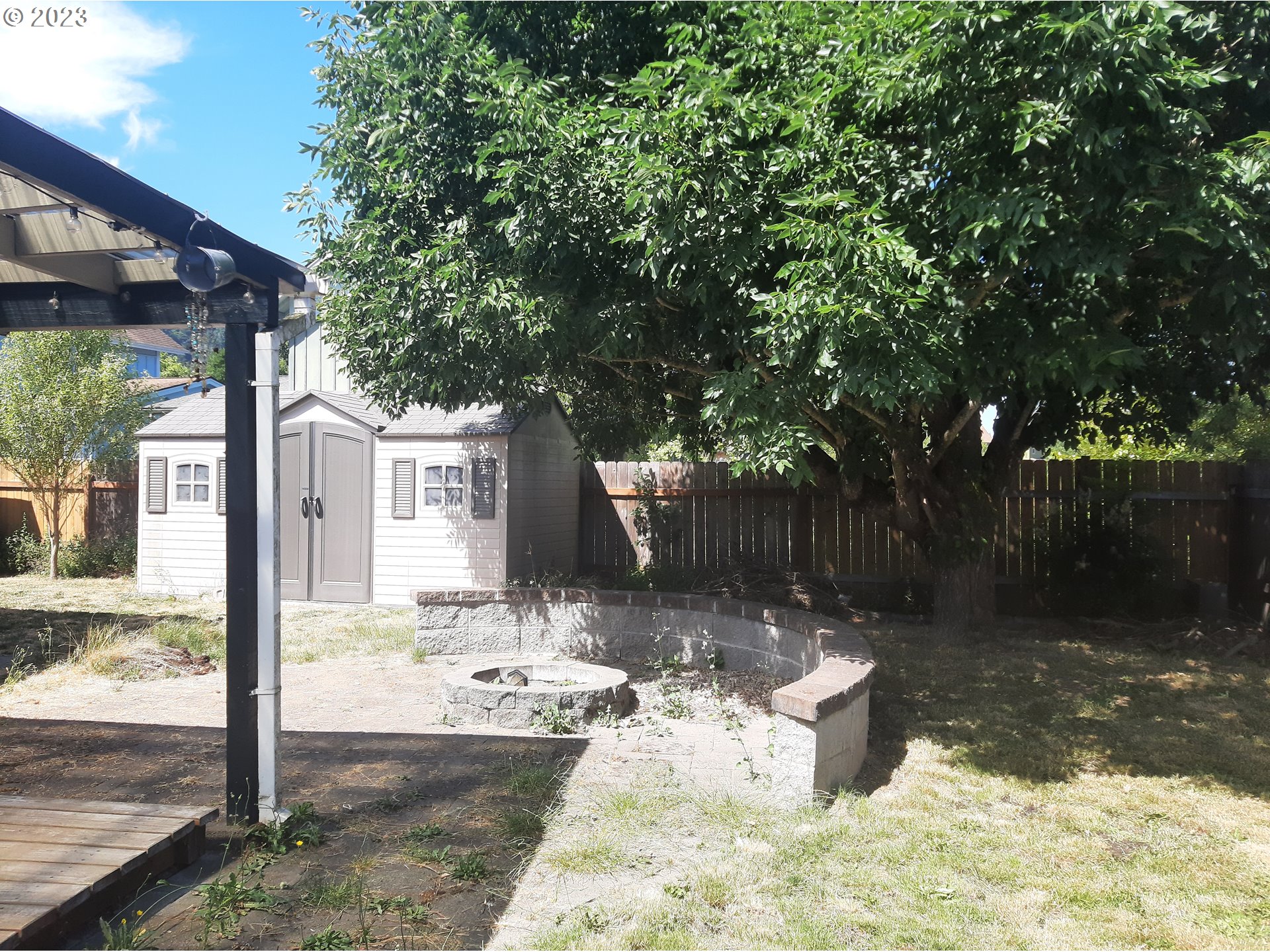 234 71st Street Springfield, OR 97478 - Photo 19 of 26 a view of a backyard with large trees and wooden fence