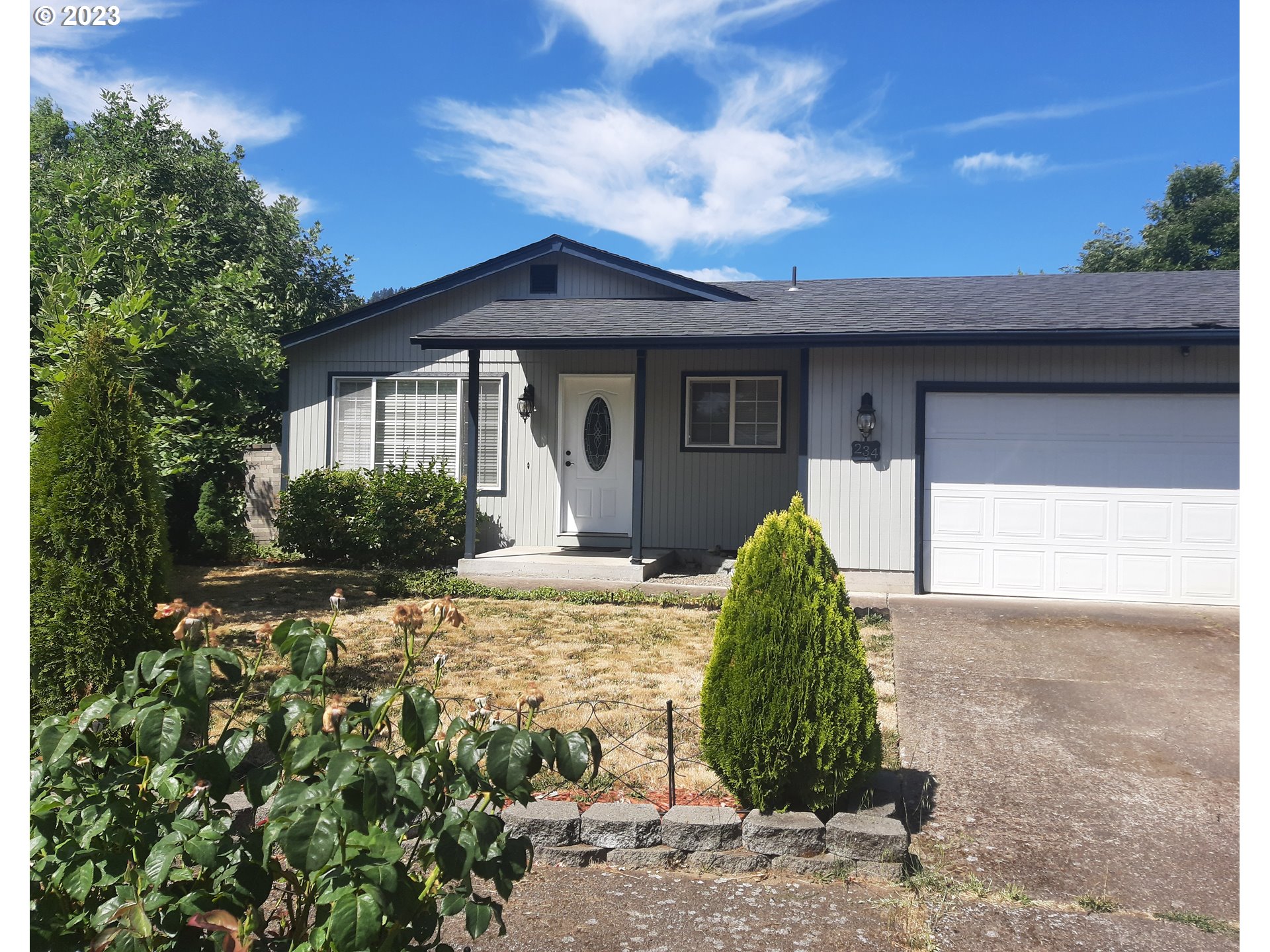 234 71st Street Springfield, OR 97478 - Photo 2 of 26 a view of a house with a yard and plants