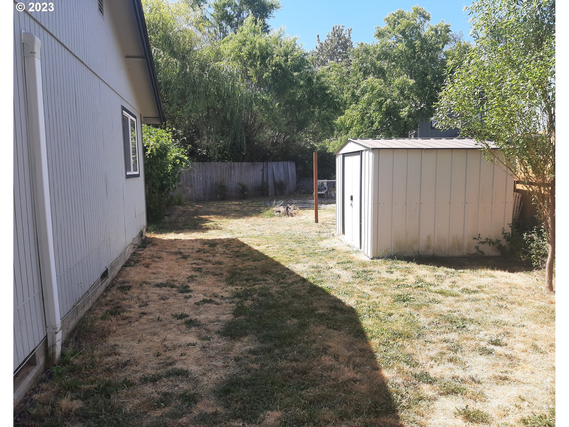 234 71st Street Springfield, OR 97478 - Photo 23 of 26 a backyard of a house with plants and trees
