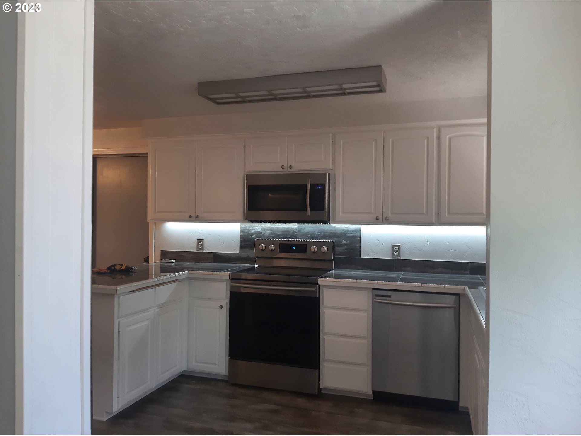 234 71st Street Springfield, OR 97478 - Photo 6 of 26 a kitchen with a stove and a microwave