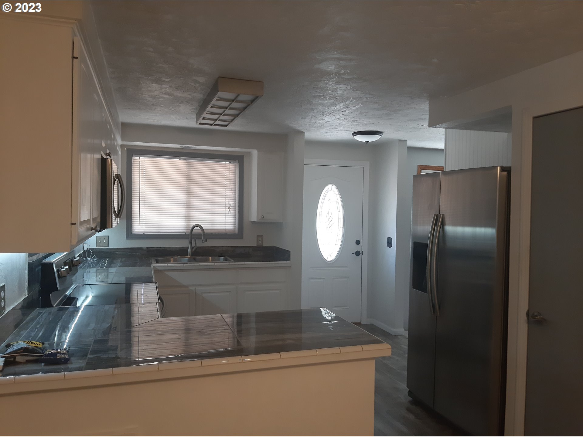 234 71st Street Springfield, OR 97478 - Photo 8 of 26 a kitchen with a refrigerator and a sink