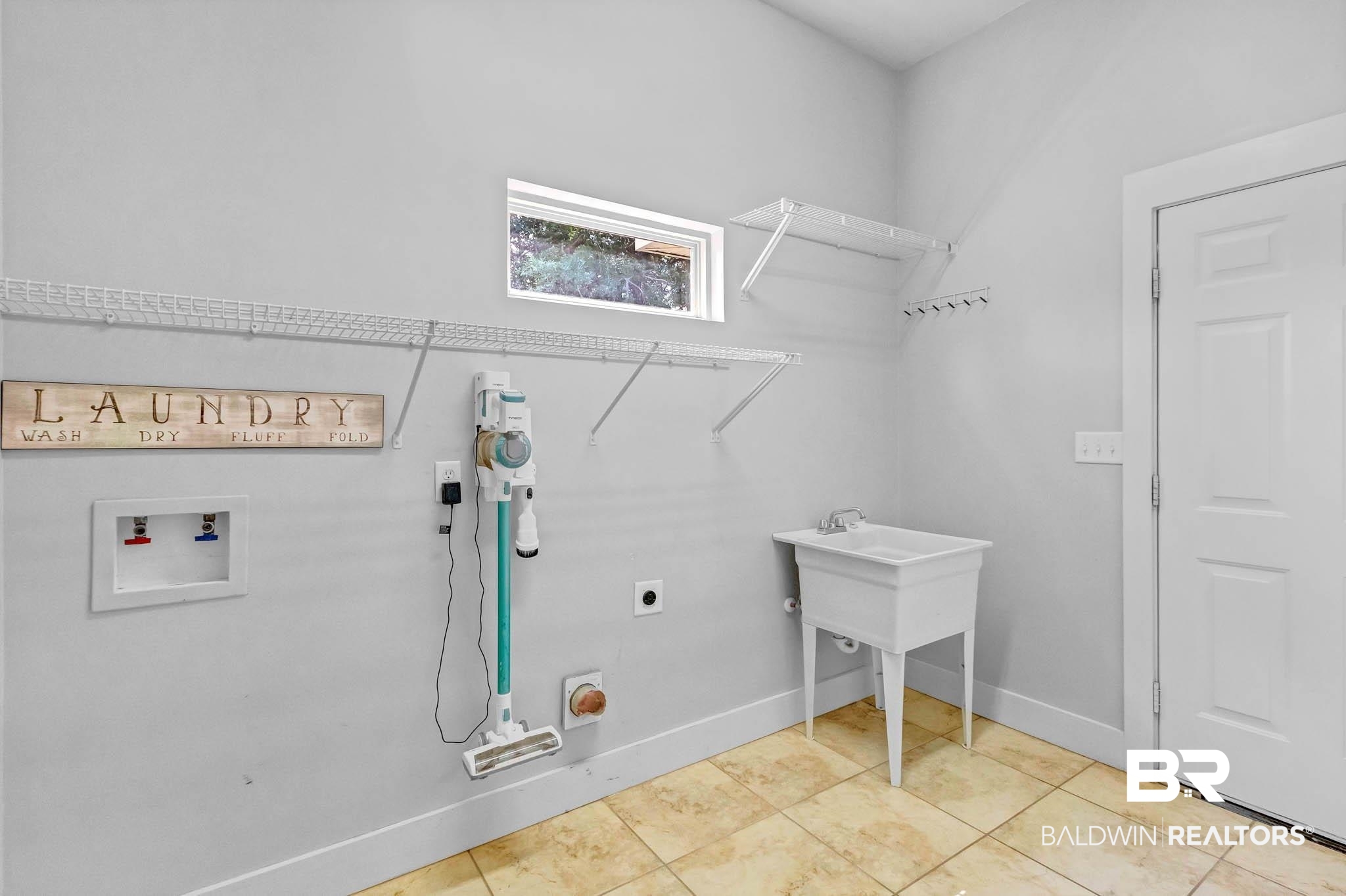 7854 Raegan Lane Daphne, AL 36527 - Photo 49 of 70 Washroom with washer hookup, hookup for an electric dryer, baseboards, and light tile patterned floors